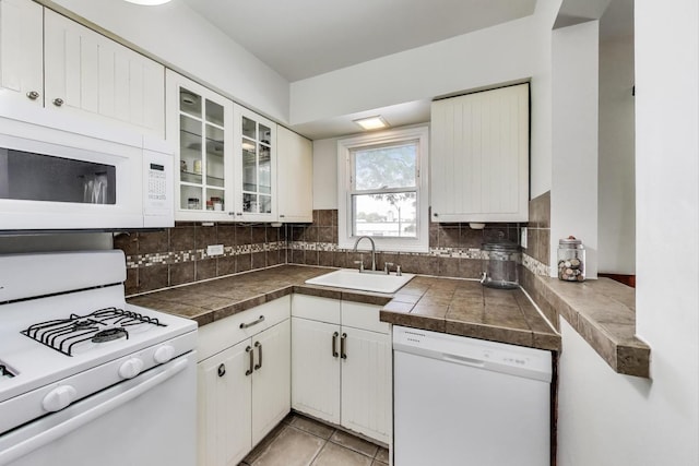 1555 Monroe Ave Unit 2, River Forest, IL 60305 - kitchen featuring white appliances, white cabinetry, glass insert cabinets, tasteful backsplash, and tile countertops