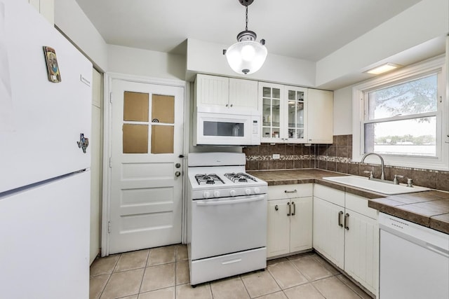 1555 Monroe Ave Unit 2, River Forest, IL 60305 - kitchen with white appliances, white cabinetry, light tile patterned floors, and glass insert cabinets