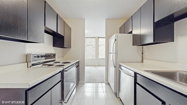 100 E Walton St Unit 14D, Chicago, IL 60611 - kitchen featuring white electric range, dishwasher, light countertops, and light tile patterned flooring