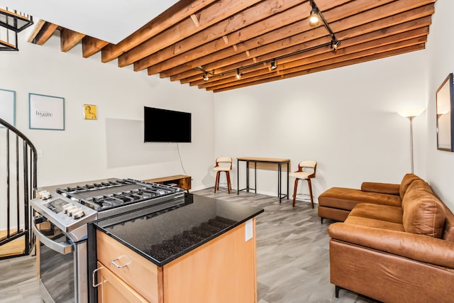 7349 Madison St Unit C, Forest Park, IL 60130 - kitchen featuring track lighting, stainless steel gas range, light brown cabinets, open floor plan, and dark stone countertops
