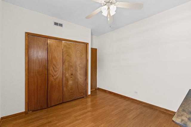 7349 Madison St Unit C, Forest Park, IL 60130 - unfurnished bedroom with wood finished floors, a closet, and a ceiling fan