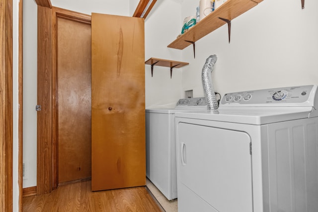 7349 Madison St Unit C, Forest Park, IL 60130 - washroom featuring separate washer and dryer and light wood-style flooring