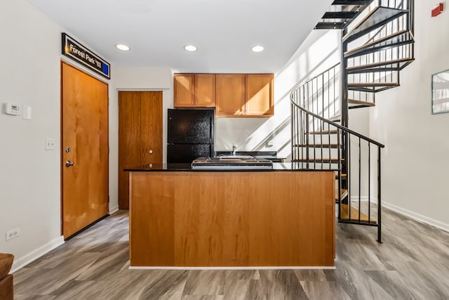 7349 Madison St Unit C, Forest Park, IL 60130 - kitchen featuring dark countertops, freestanding refrigerator, brown cabinets, light wood-style floors, and recessed lighting