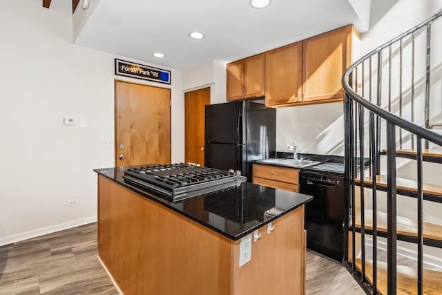 7349 Madison St Unit C, Forest Park, IL 60130 - kitchen with black appliances, a center island, dark stone countertops, recessed lighting, and brown cabinets