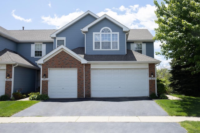 5451 Elizabeth Pl Unit 0, Rolling Meadows, IL 60008 - traditional home featuring driveway, roof with shingles, brick siding, and an attached garage