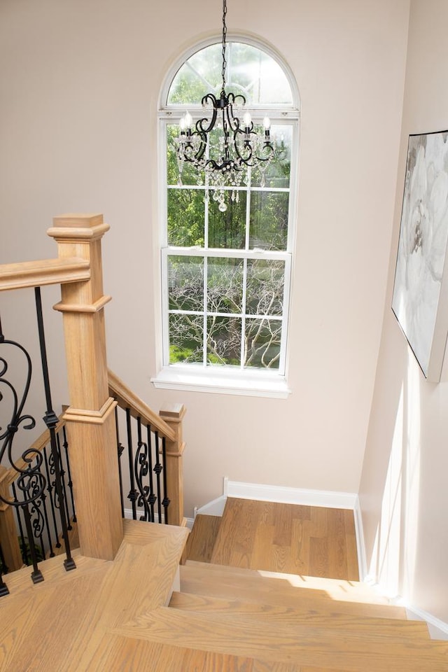 5451 Elizabeth Pl Unit 0, Rolling Meadows, IL 60008 - stairway featuring a chandelier, wood finished floors, and healthy amount of natural light