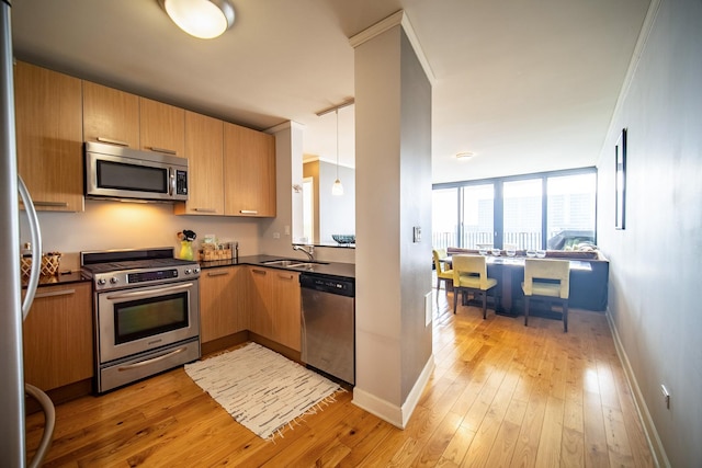 225 N Columbus Dr Unit 7207, Chicago, IL 60601 - kitchen with dark countertops, appliances with stainless steel finishes, light wood-style floors, and hanging light fixtures