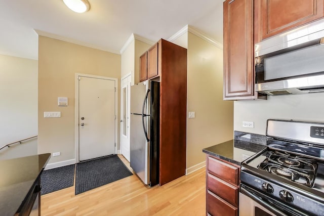 1949 N Whipple St Unit 1, Chicago, IL 60647 - kitchen featuring stainless steel appliances, light wood finished floors, ornamental molding, and dark stone counters