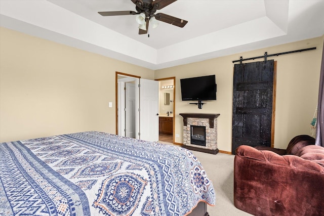 25516 W Gateway Cir, Plainfield, IL 60585 - carpeted bedroom featuring a barn door, a fireplace, and ceiling fan