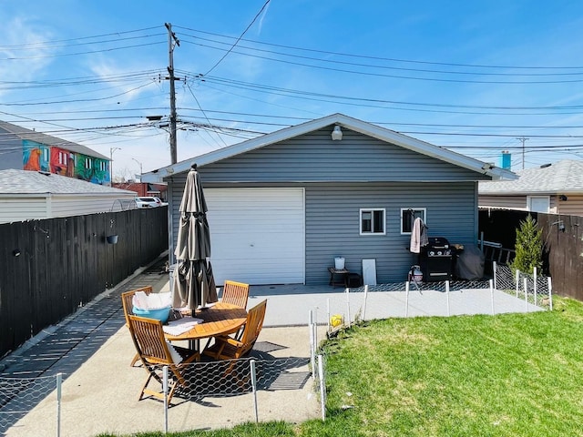 5410 S Harding Ave, Chicago, IL 60632 - rear view of house featuring a fenced backyard, a patio area, and an outbuilding