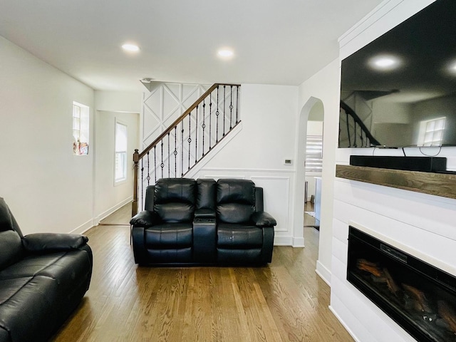 5410 S Harding Ave, Chicago, IL 60632 - living room featuring stairway, wood finished floors, arched walkways, recessed lighting, and a glass covered fireplace