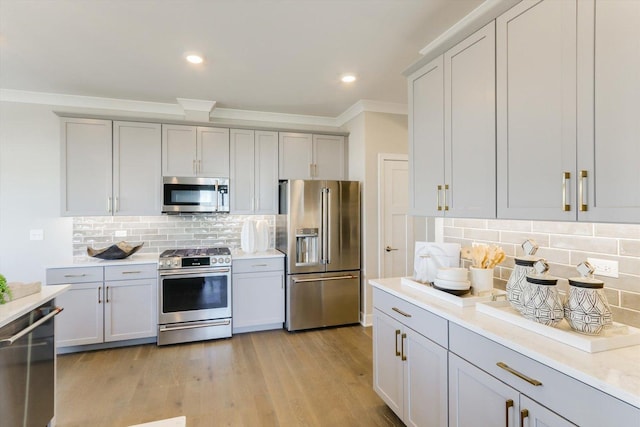 25452 W Stockwell Dr, Plainfield, IL 60544 - kitchen with appliances with stainless steel finishes, crown molding, decorative backsplash, light countertops, and gray cabinets