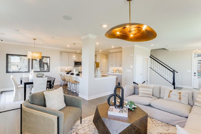 25452 W Stockwell Dr, Plainfield, IL 60544 - living room with light wood-style flooring, stairway, recessed lighting, a chandelier, and ornamental molding