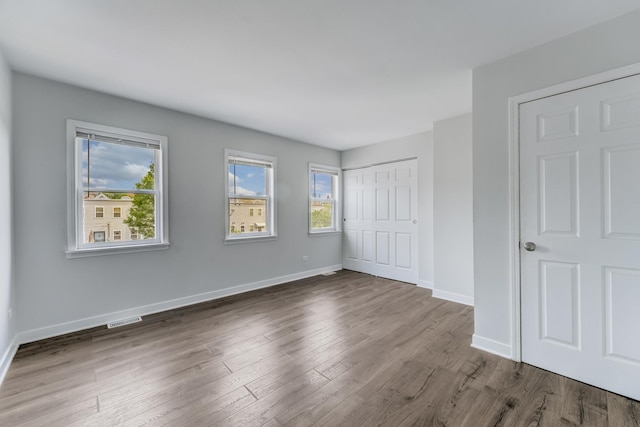 1166 W Cullerton St, Chicago, IL 60608 - unfurnished bedroom featuring wood finished floors and a closet