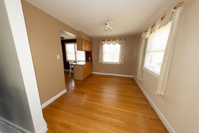 1406 Portsmouth Ave, Westchester, IL 60154 - unfurnished dining area featuring light wood-type flooring and baseboards