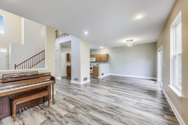 574 S Jade Ln, Round Lake, IL 60073 - living room with stairs, light wood finished floors, and recessed lighting