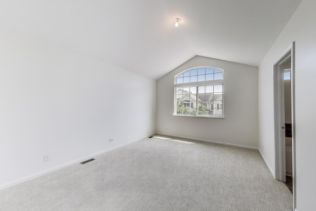 574 S Jade Ln, Round Lake, IL 60073 - unfurnished room featuring lofted ceiling and carpet