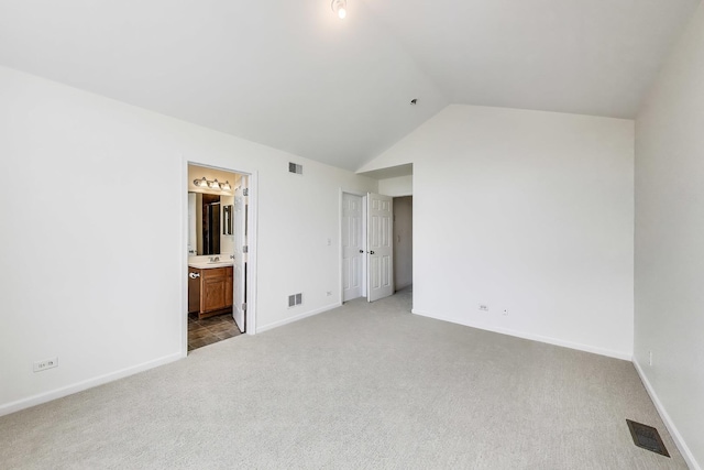 574 S Jade Ln, Round Lake, IL 60073 - unfurnished bedroom featuring carpet, vaulted ceiling, and ensuite bathroom