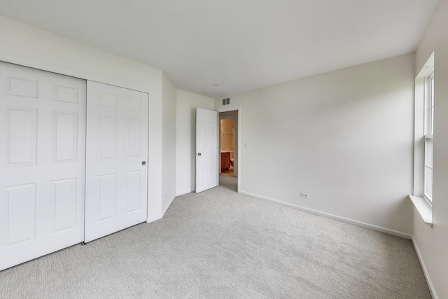 574 S Jade Ln, Round Lake, IL 60073 - unfurnished bedroom featuring carpet floors and a closet