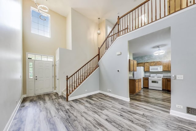 574 S Jade Ln, Round Lake, IL 60073 - entrance foyer featuring a high ceiling, wood finished floors, and stairway