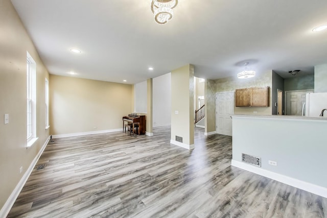 574 S Jade Ln, Round Lake, IL 60073 - unfurnished living room featuring wood finished floors, recessed lighting, and stairway