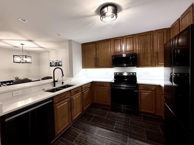1905 Silverstone Dr Unit 1905, Carpentersville, IL 60110 - kitchen featuring black appliances, light countertops, decorative light fixtures, brown cabinets, and a peninsula