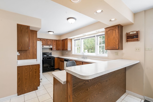 5113 W 79th Pl, Burbank, IL 60459 - kitchen with a peninsula, brown cabinetry, light countertops, light tile patterned flooring, and white appliances