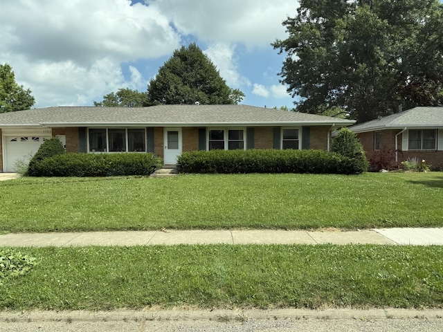 1108 Westview, Normal, IL 61761 - ranch-style home featuring an attached garage, brick siding, a front yard, and a shingled roof