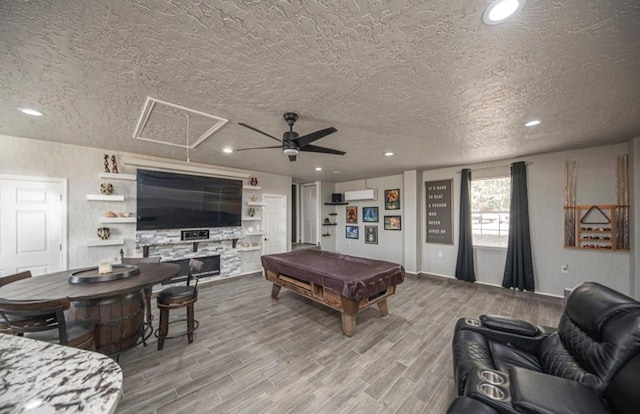 playroom with light wood finished floors, attic access, billiards, a ceiling fan, and a textured ceiling