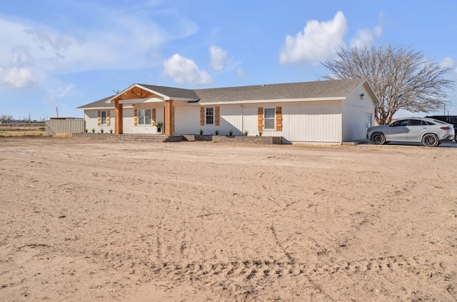 single story home featuring a porch and fence