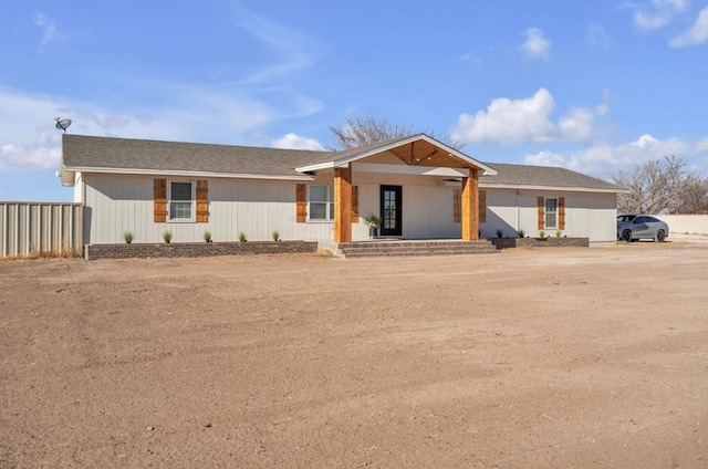 single story home with covered porch and fence