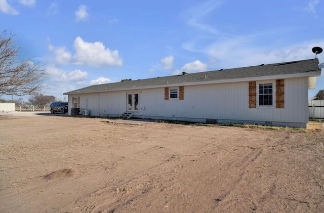 back of house with crawl space and fence