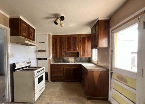 3105 Travis Ave, Midland, TX 79701 - kitchen featuring white range with gas cooktop, under cabinet range hood, and light countertops