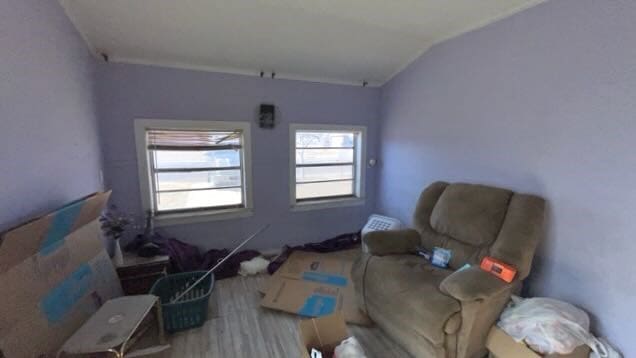 sitting room with lofted ceiling and wood finished floors