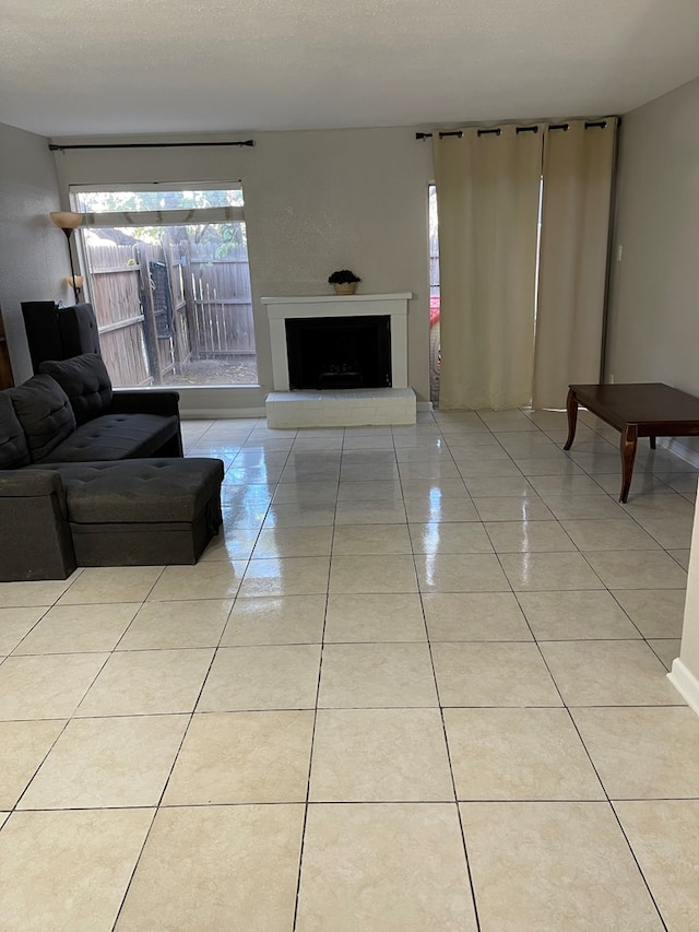 living room with light tile patterned flooring and a textured ceiling