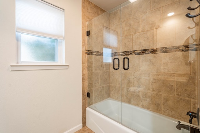 full bath featuring combined bath / shower with glass door and baseboards