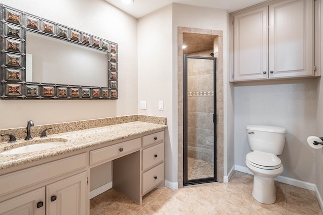 bathroom with toilet, a shower stall, vanity, tile patterned flooring, and baseboards