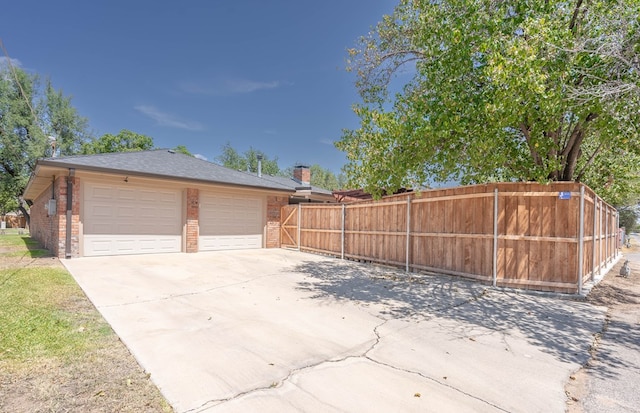 exterior space featuring fence and driveway