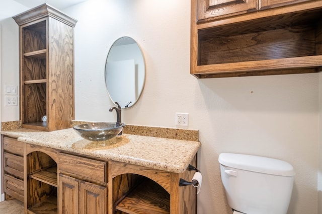 bathroom featuring toilet and vanity