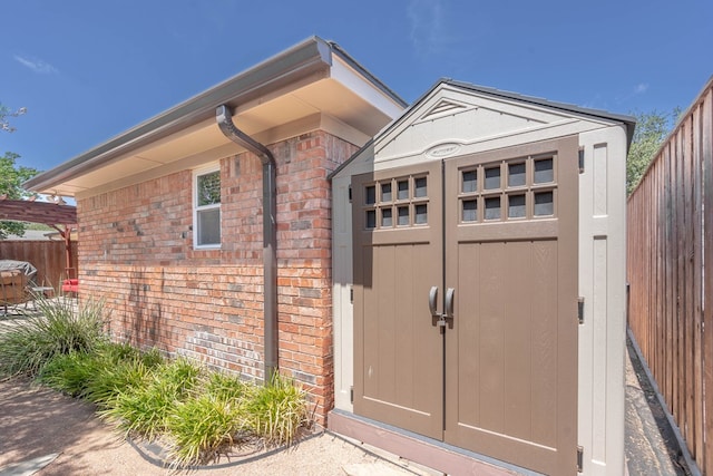 view of shed featuring fence