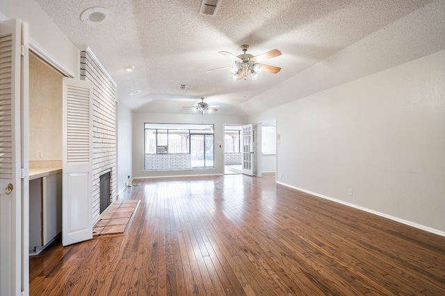 unfurnished living room with a fireplace with raised hearth, ceiling fan, baseboards, vaulted ceiling, and dark wood-style floors