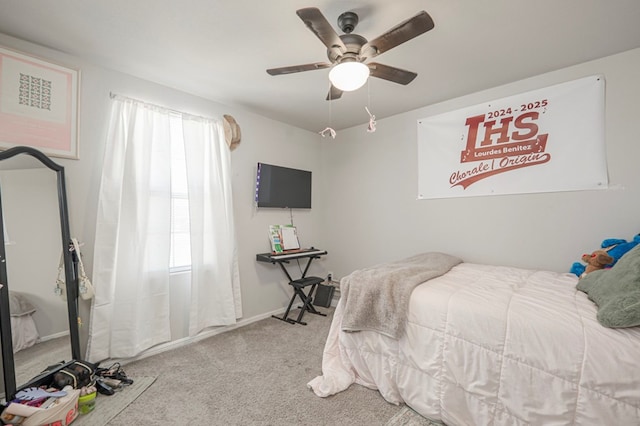 bedroom with light carpet, ceiling fan, and baseboards