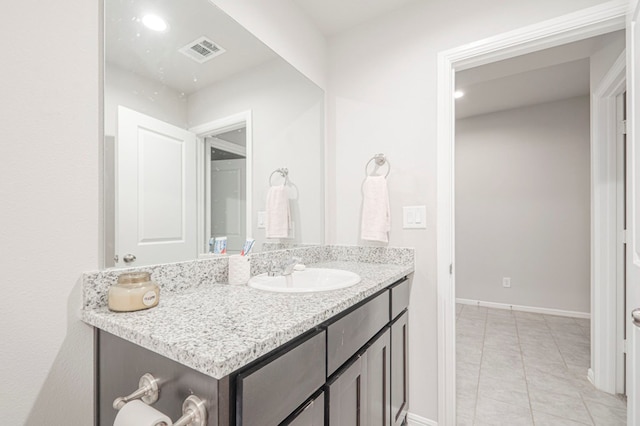 bathroom with tile patterned floors, baseboards, visible vents, and vanity