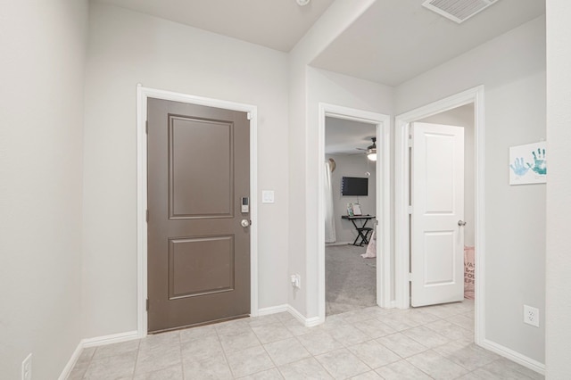 entrance foyer featuring light tile patterned flooring, visible vents, and baseboards