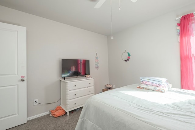 carpeted bedroom with a ceiling fan and baseboards