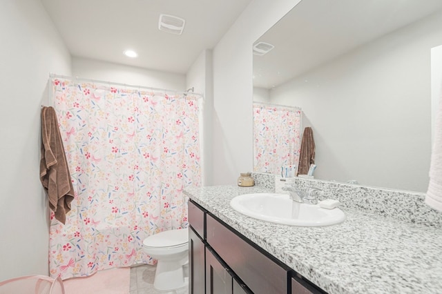 bathroom featuring tile patterned flooring, visible vents, vanity, and toilet