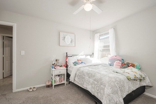 carpeted bedroom featuring a ceiling fan and baseboards