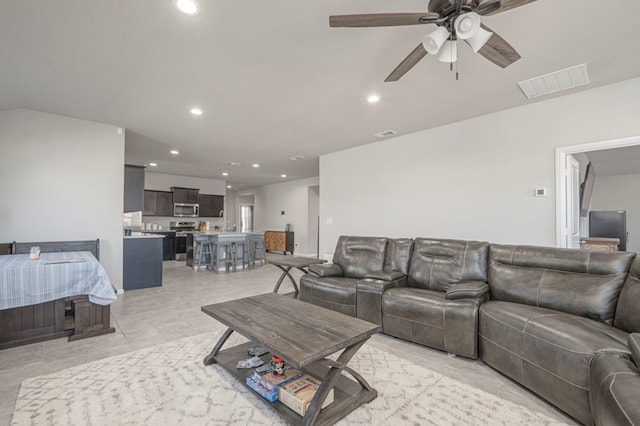 living room with a ceiling fan, recessed lighting, visible vents, and light tile patterned flooring