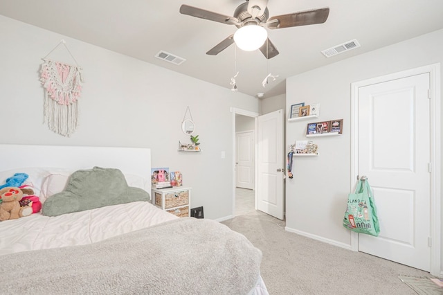 bedroom with a ceiling fan, light colored carpet, visible vents, and baseboards