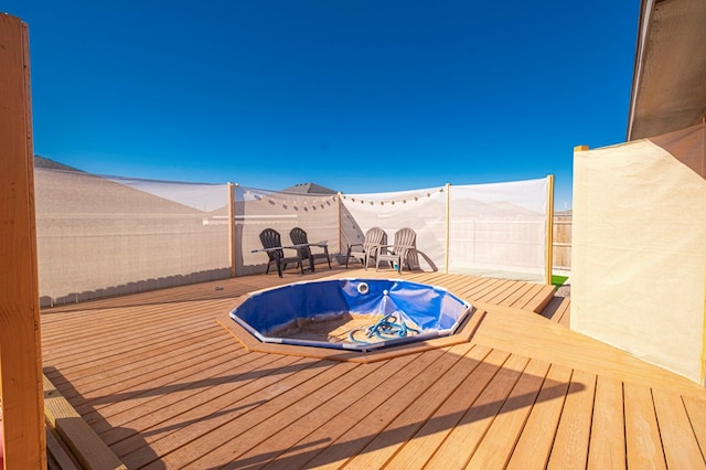 view of swimming pool featuring hot tub deck surround and a wooden deck